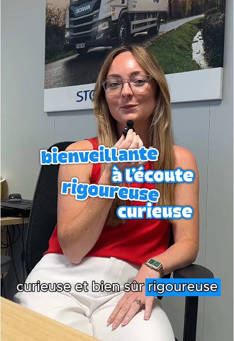 Employee speaking into a microphone with French captions describing her qualities.